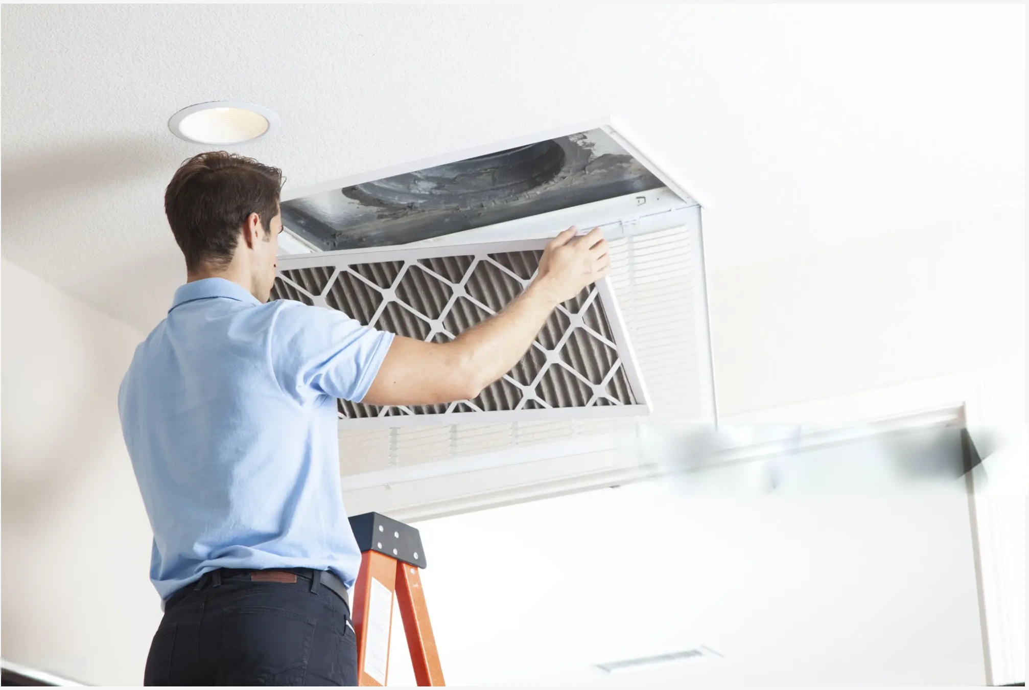 Technician cleaning air duct with filter replacement in Abu Dhabi