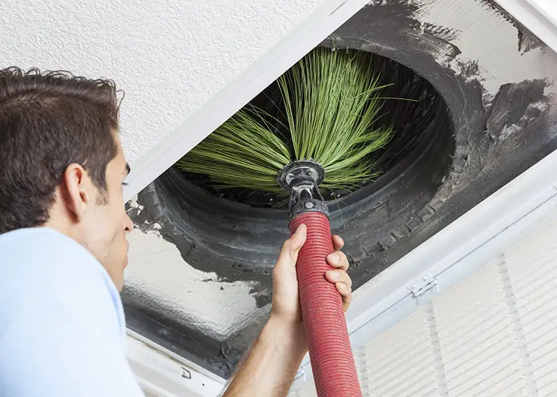 Professional AC duct cleaning service using advanced equipment.